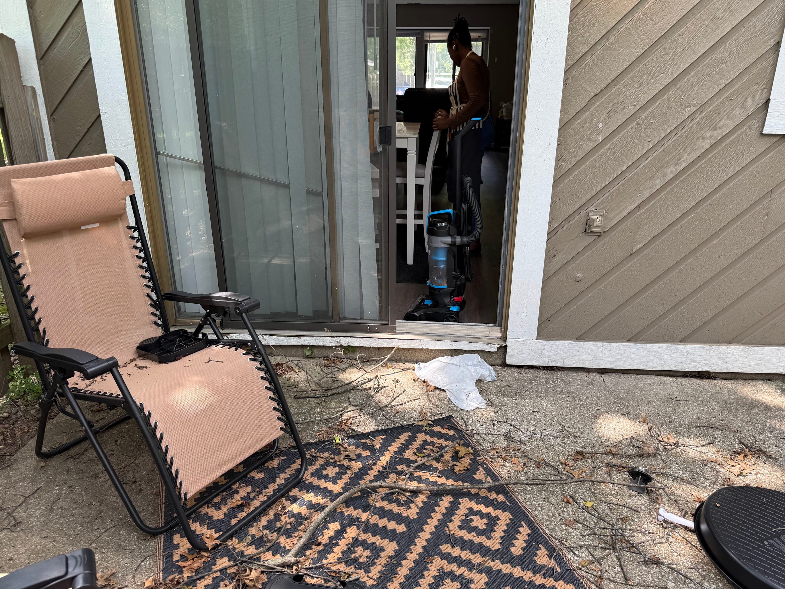 A PiFresh cleaner vacuuming inside a home beside a sliding patio door